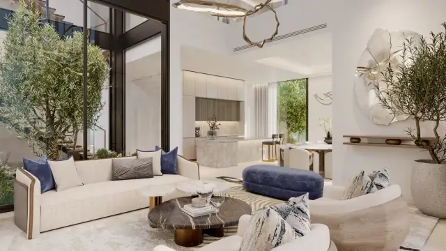 Double-height living room opening onto a planted courtyard