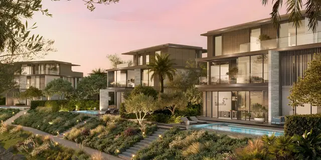 Villas with private pools and landscaped gardens at dusk